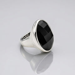 A silver signet-style ring featuring a large, faceted black round gemstone, photographed on a clean white background.