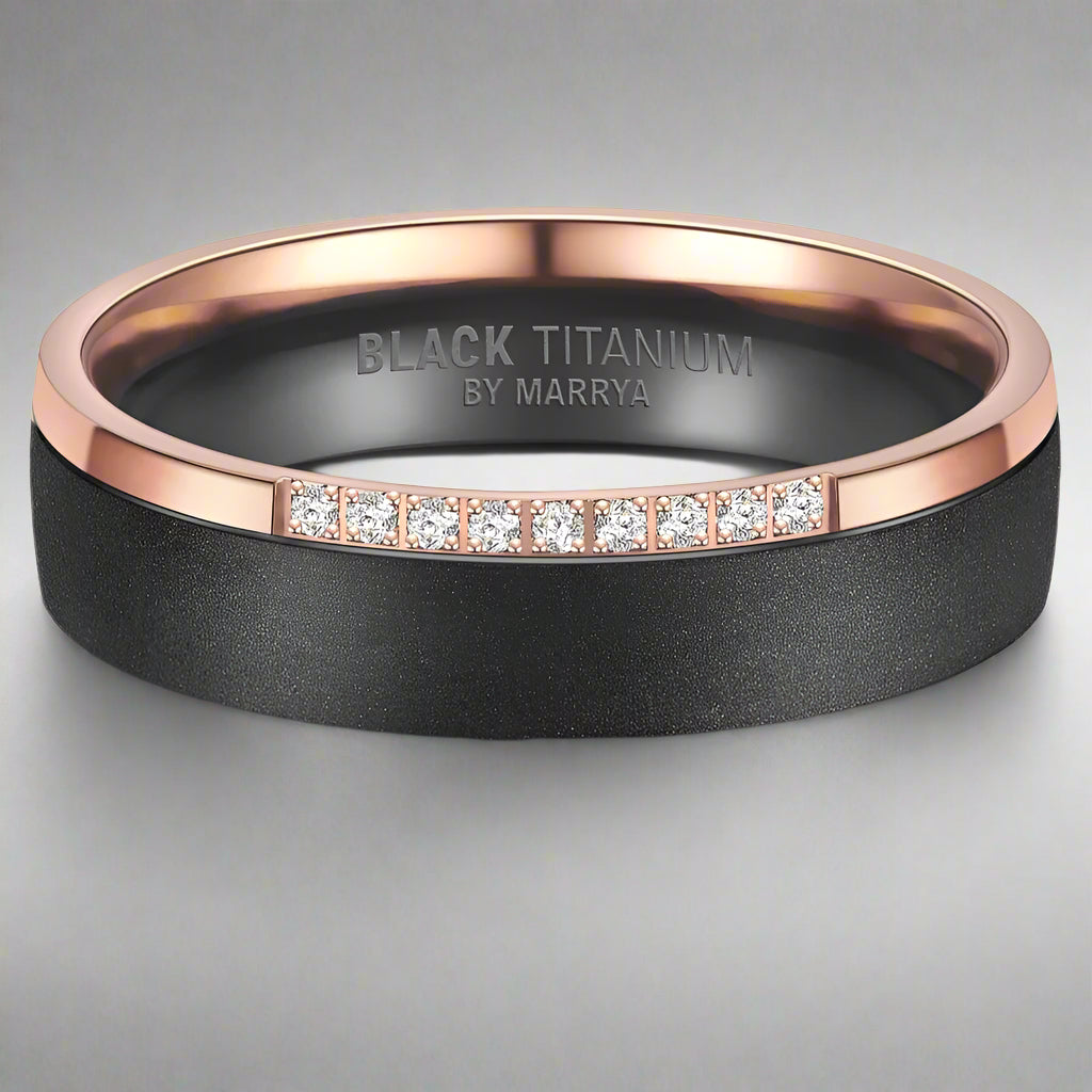 Black titanium ring with rose gold band and diamond accents on a white background