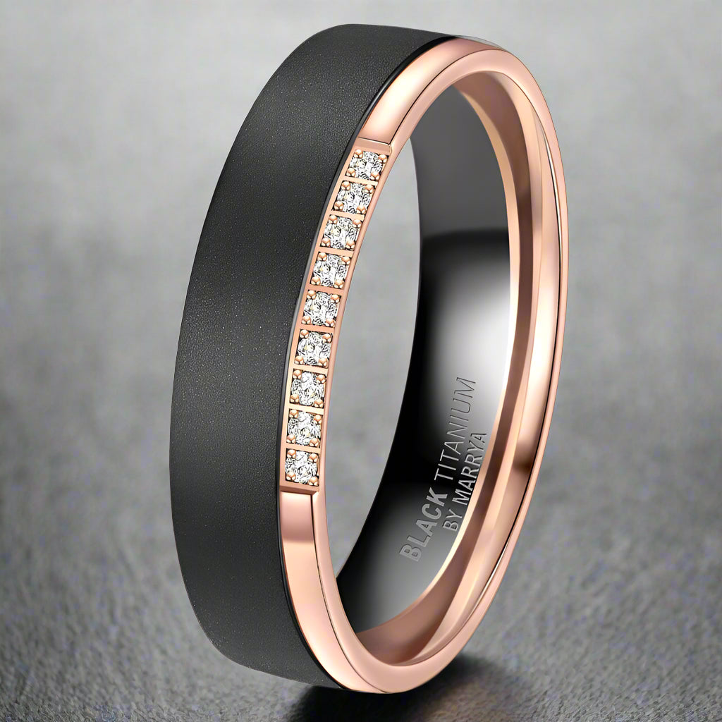 Black and rose gold ring with diamond accents on a white background