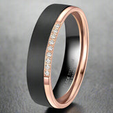 Black and rose gold ring with diamond accents on a white background