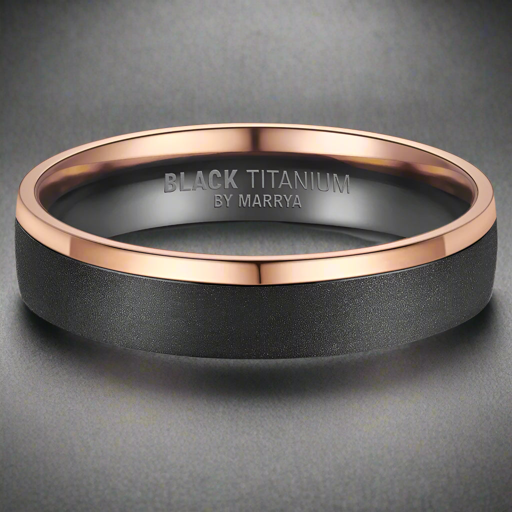Black titanium ring with rose gold accent on a white background