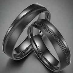 Two black rings with engraved text on a white background
