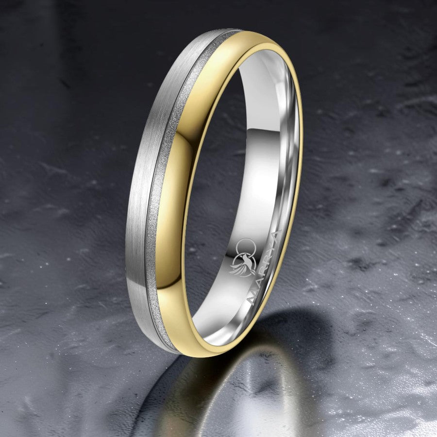Two-toned ring with gold and silver finish on a dark textured background