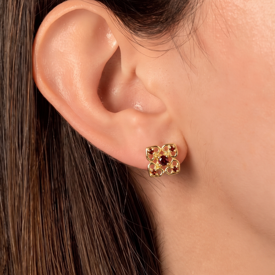 Gold and garnet earrings on model