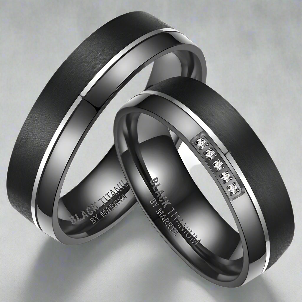 Two black titanium rings with engraved text on a white background