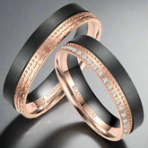two black titanium and rose gold rings