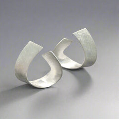 silver earrings with a scratched finish