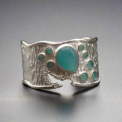 Silver ring with amazonite stones on a dark background