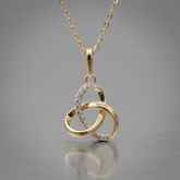 gold trinity knot pendant with cubic zircona