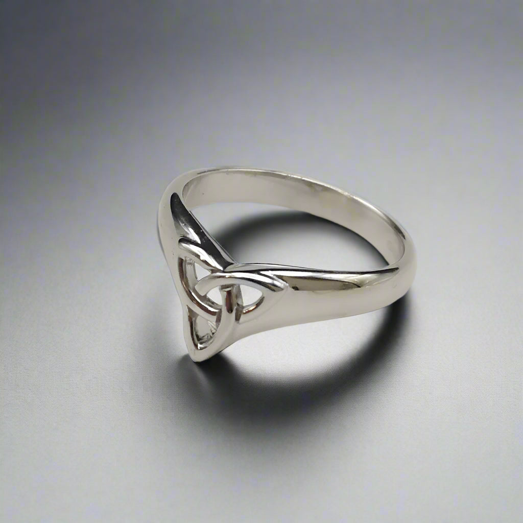 Silver ring with a triangular design on a light gray background