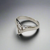 Silver ring with a triangular design on a light gray background