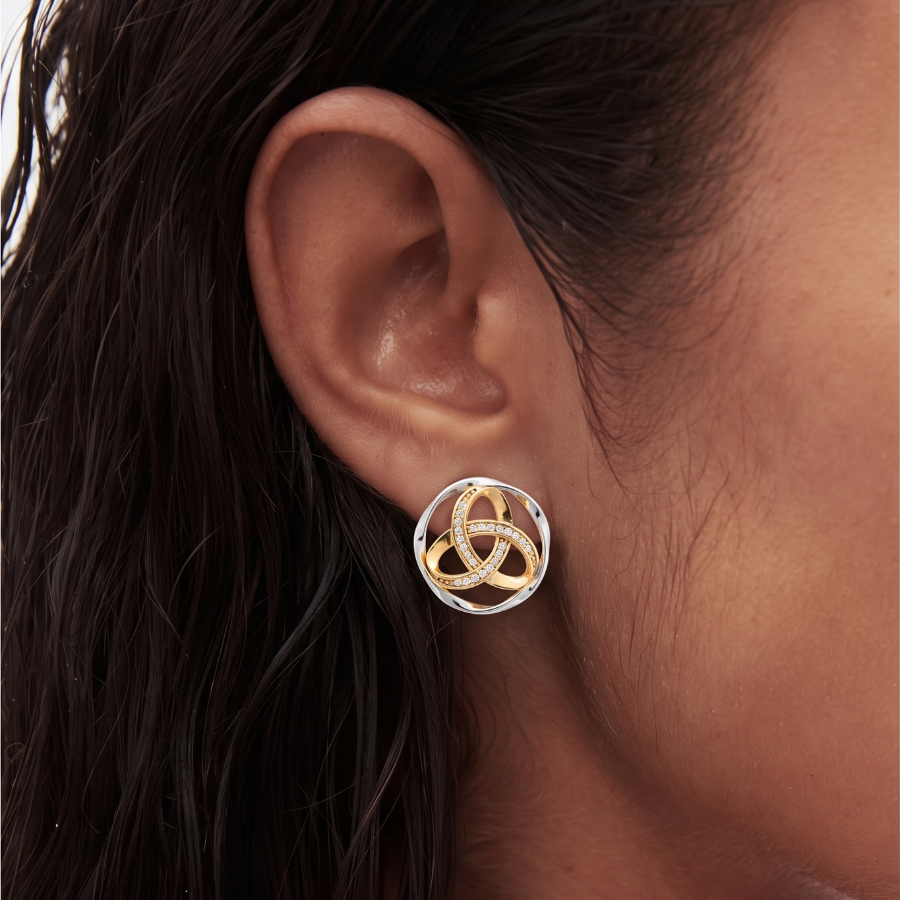 close up of a models ear wearing trinity knot earrings