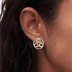 close up of a models ear wearing trinity knot earrings