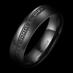 Black titanium ring with engraved details on a black background