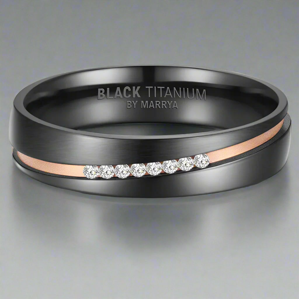 Black titanium ring with rose gold accents and diamond-like stones on a gray background