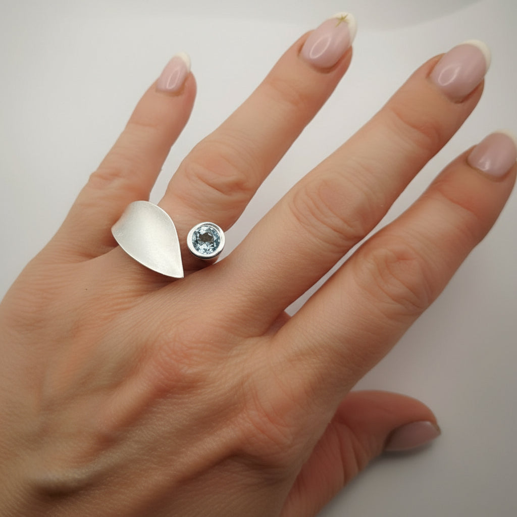 blue topaz ring on hand