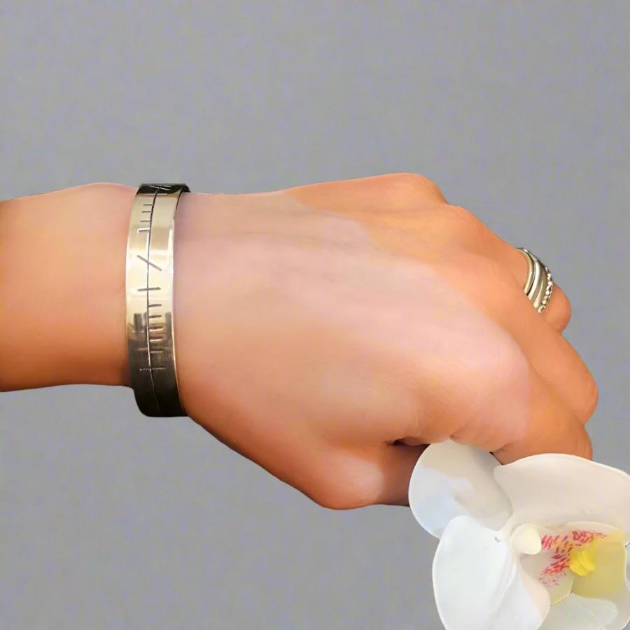 Ogham Bracelet in silver on womans wrist - doyle design dublin
