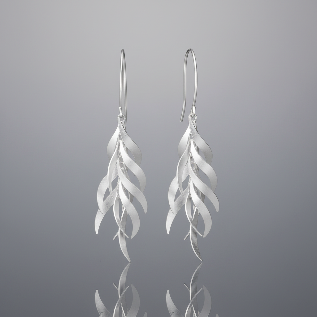 A pair of silver drop earrings with a layered, feather-like wavy design, shown against a plain white background.