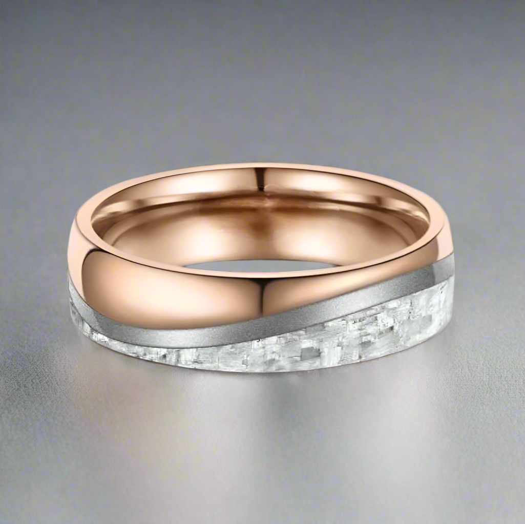 Rose gold and silver ring on a white background