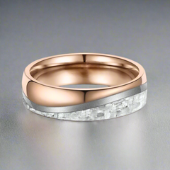Rose gold and silver ring on a white background