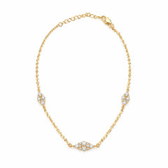 A delicate gold chain bracelet with three pavé diamond clusters spaced along the chain, displayed on a clean white background.