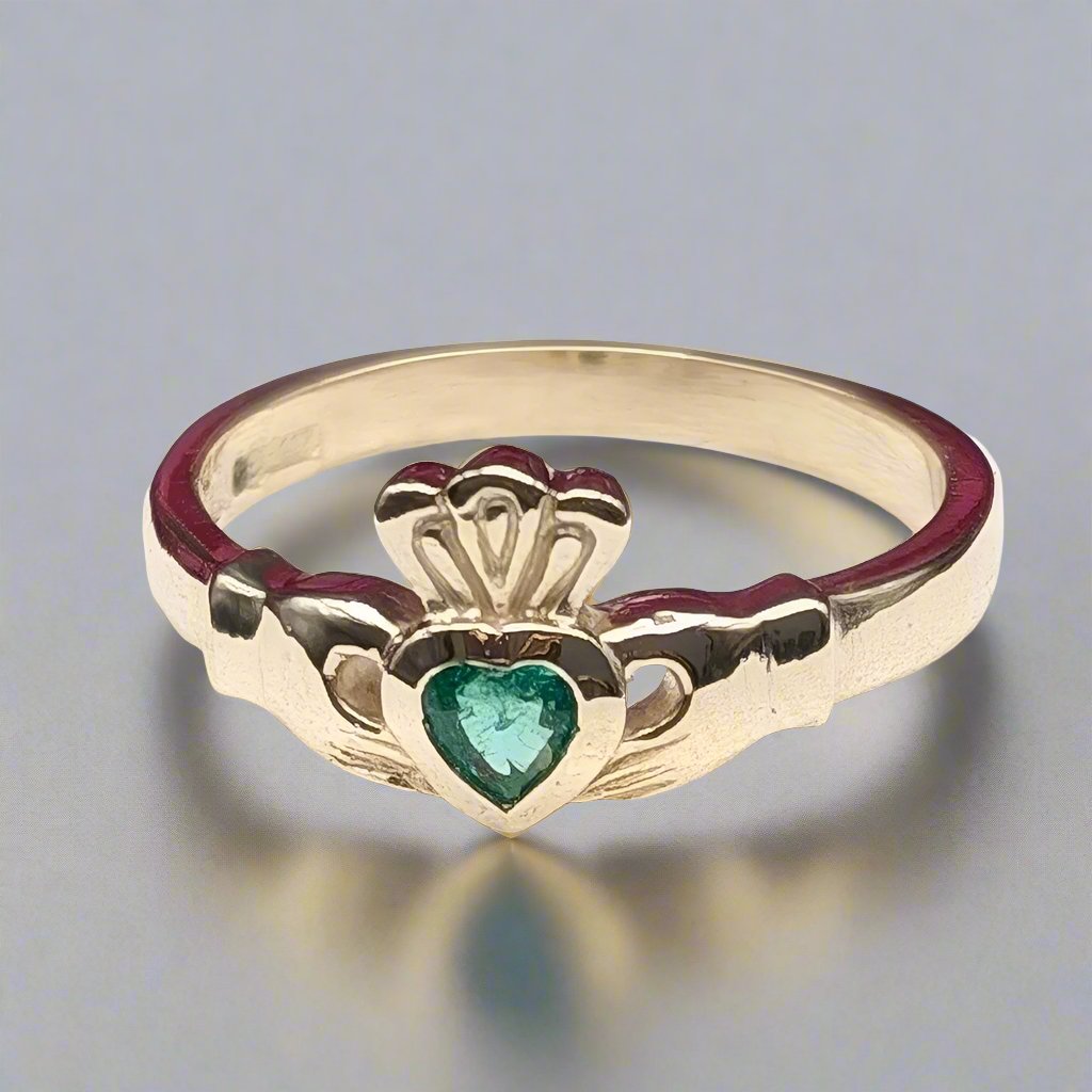 Gold claddagh ring set with heart shaped emerald