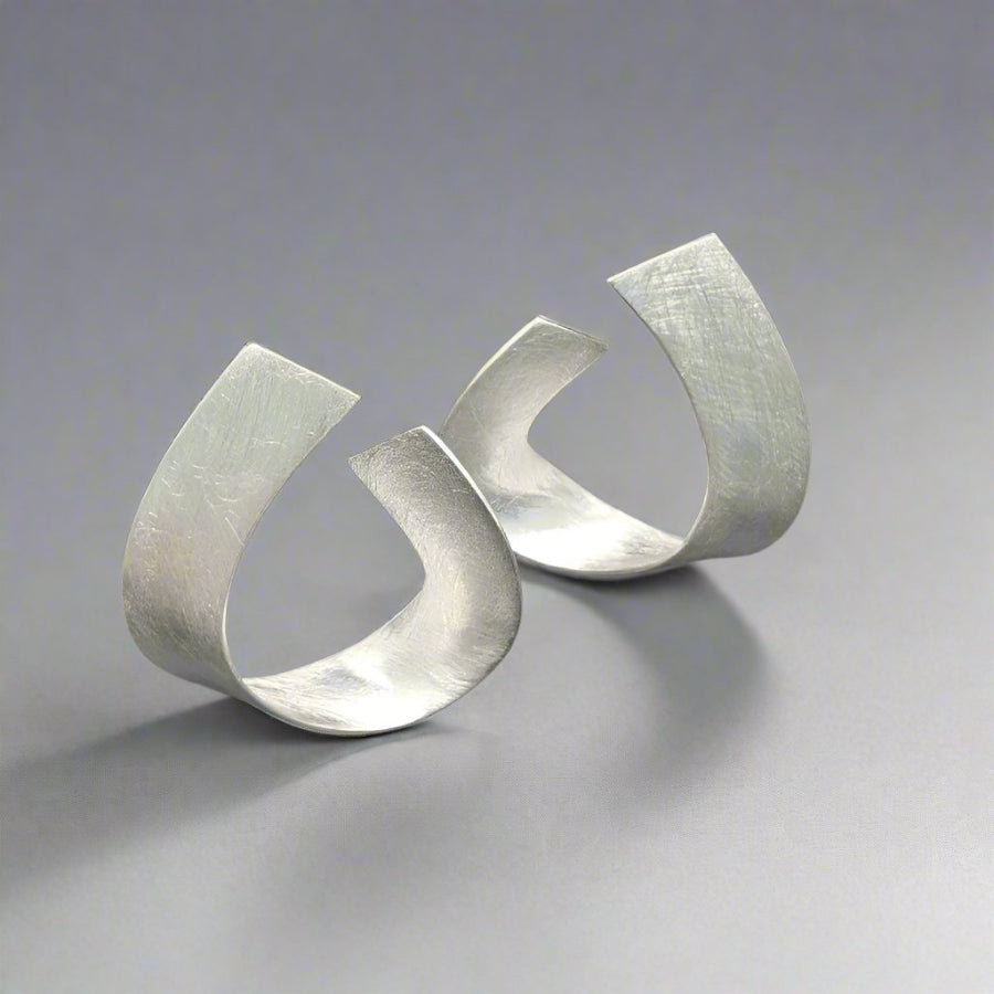 silver earrings with a scratched finish