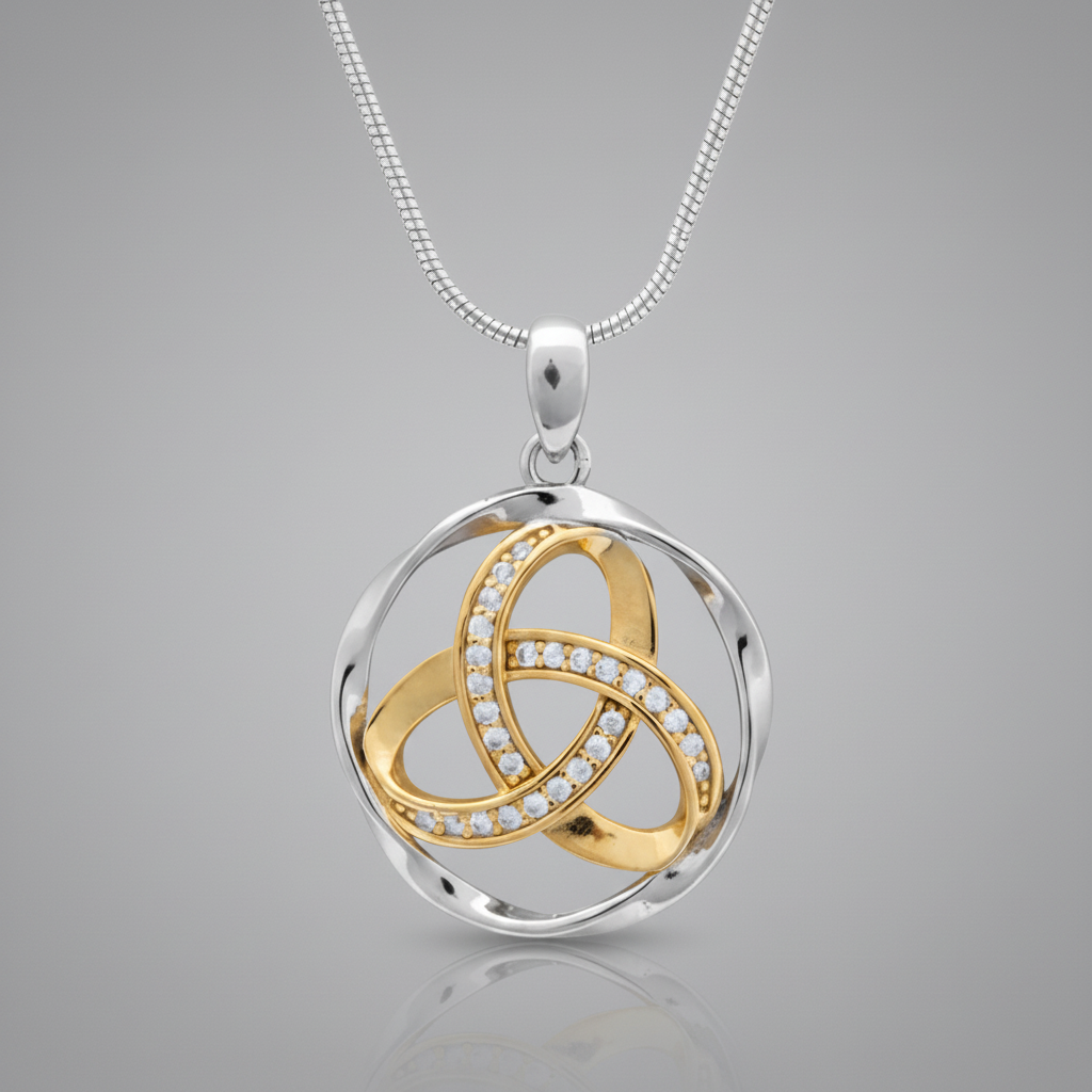A two-tone silver and gold pendant necklace on a white background. The pendant features a silver-toned circular frame with interwoven gold-toned loops, one of which is lined with small clear stones.