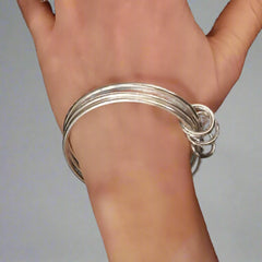 Multi strand silver bracelet on the wrist - Doyle Design Dublin