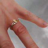 Gold Claddagh Ring on the finger - Doyle Design Dublin